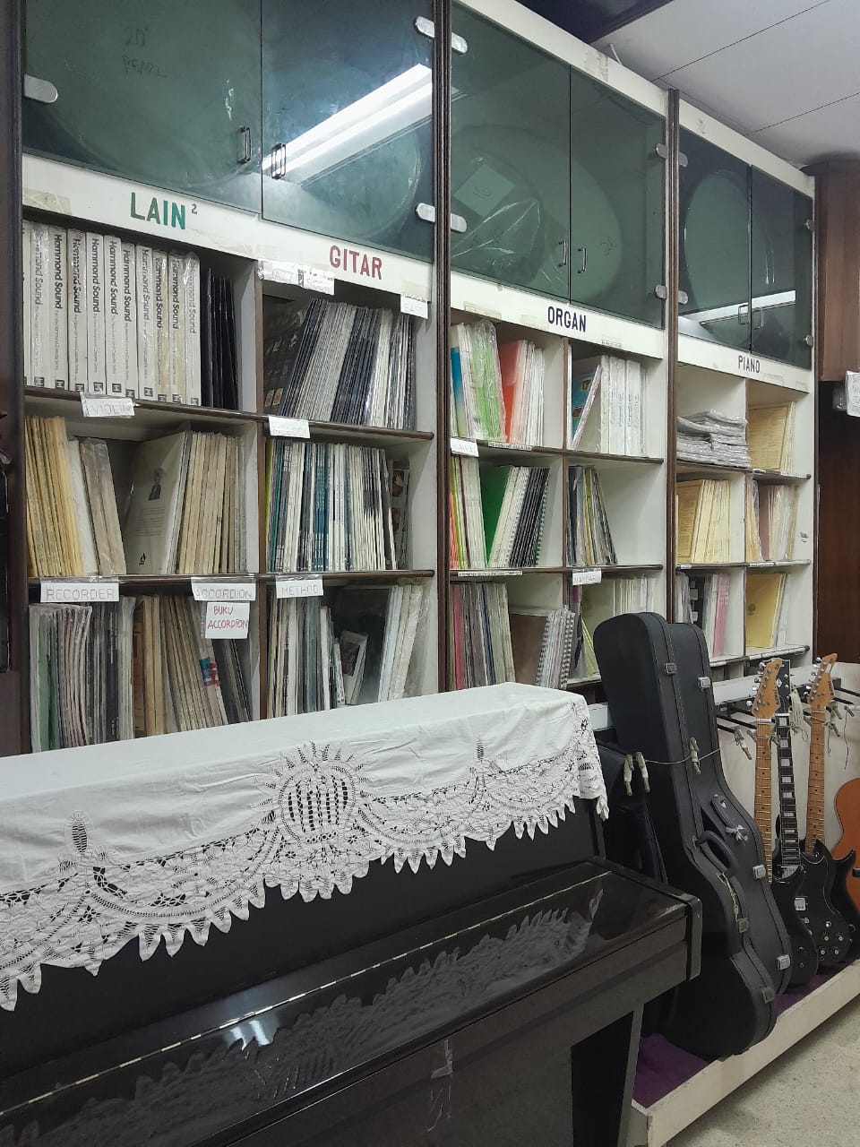 Close-up of a piano with the brand name 'Strauss' on it